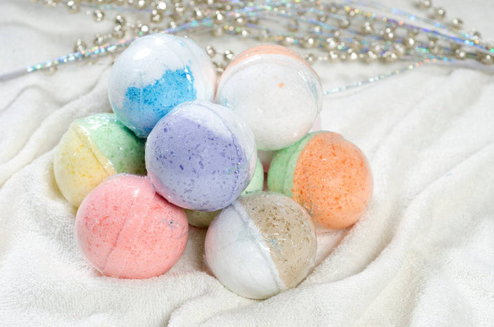 Colorful Epsom salt bath bombs stacked on white towel for mess-free relaxing soak