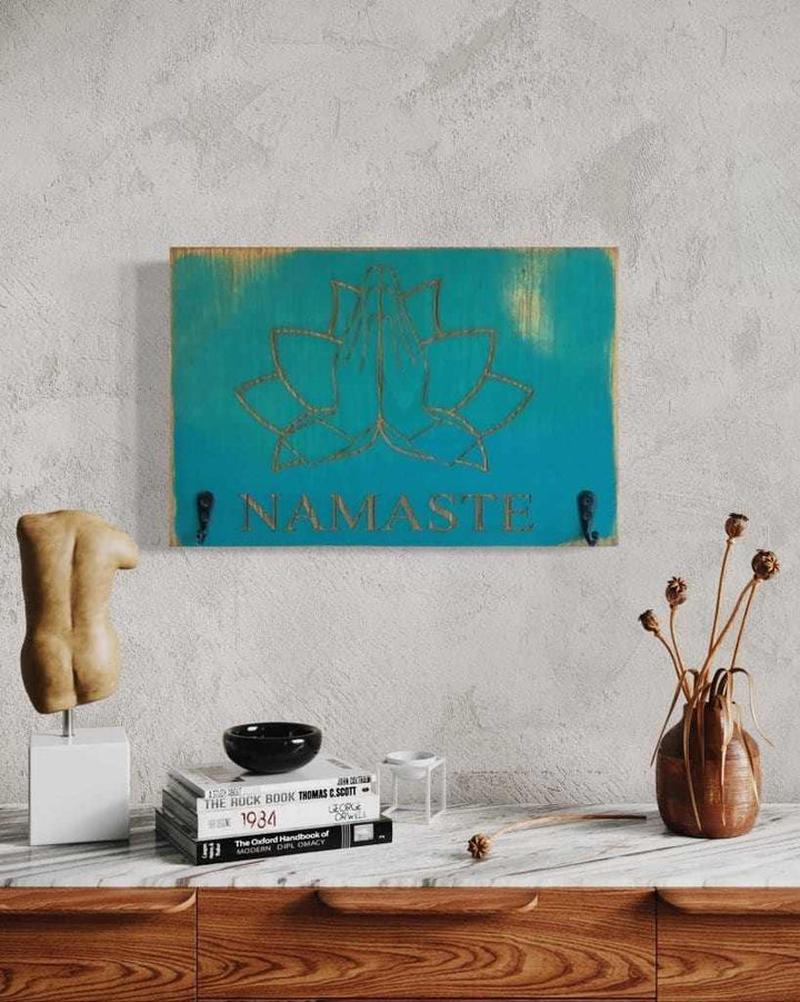 Namaste keychain holder with engraved design in antiqued surf blue wood, ideal for yoga enthusiasts.