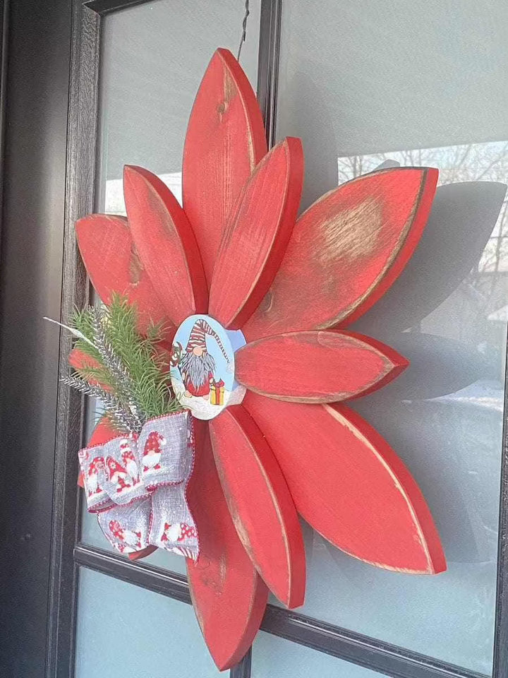 Hand-painted Christmas flower gnome décor with red antique petals and festive bow for outdoor display.