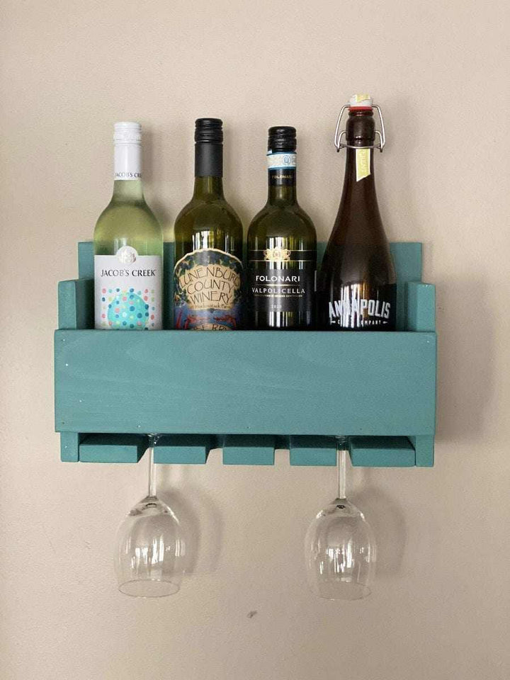 Rustic wall-mounted wine bottle and glass holder made of stained pine wood, holding four wine bottles and two glasses.