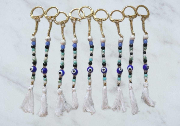 Evil Eye keychain with glass stones, howlite, macramé tassel, and gold locking ring.