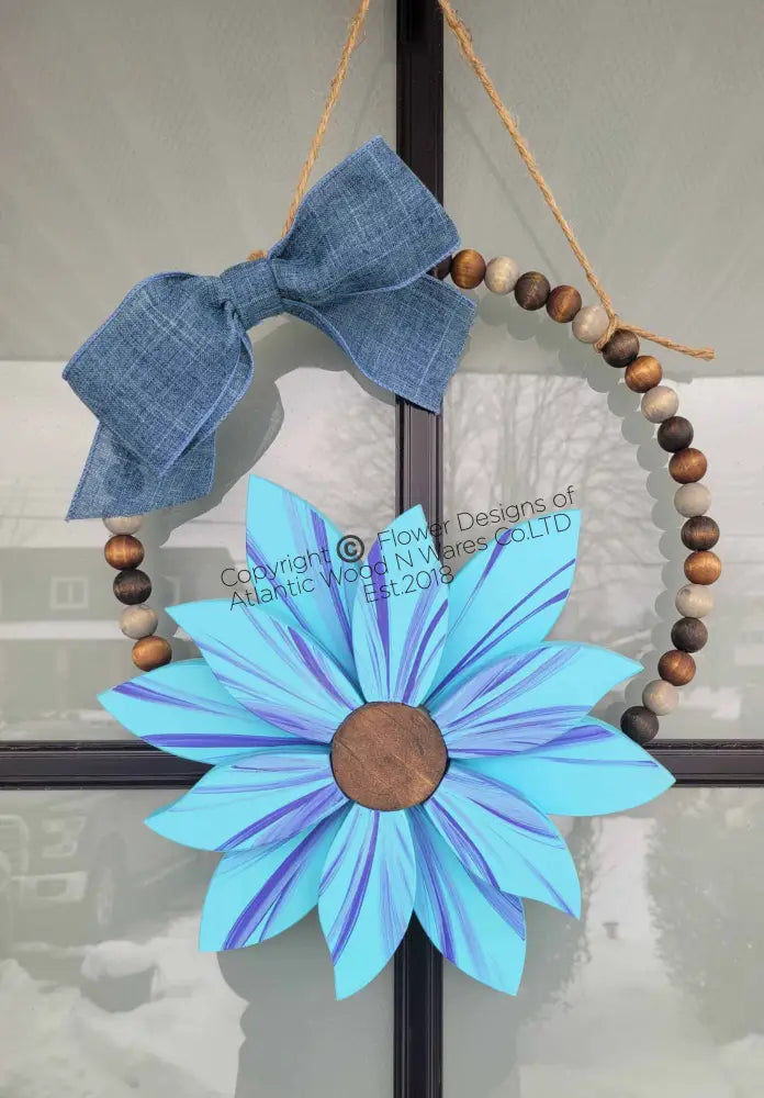 handmade flower with wooden bead with handmade bow attached with jute rope hanger