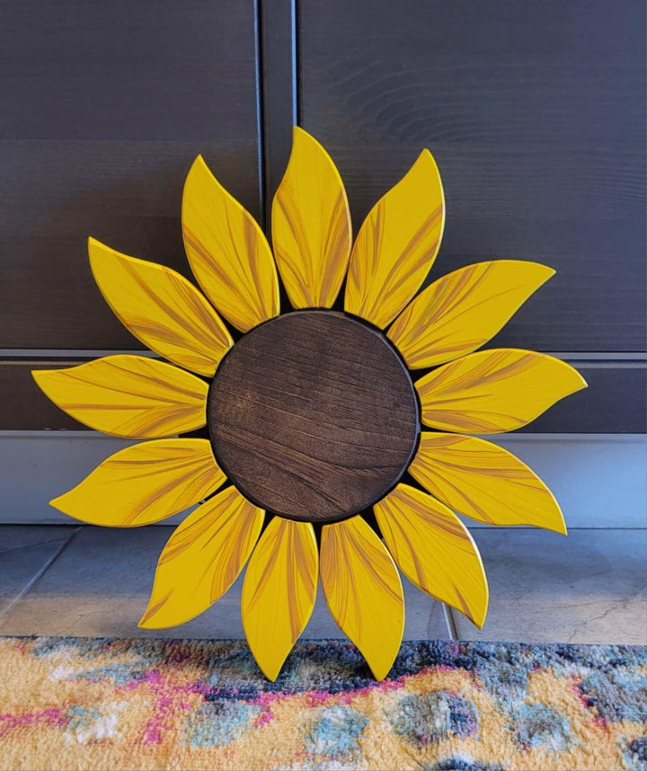 Handcrafted wooden sunflower door decoration with vibrant yellow petals and realistic details.