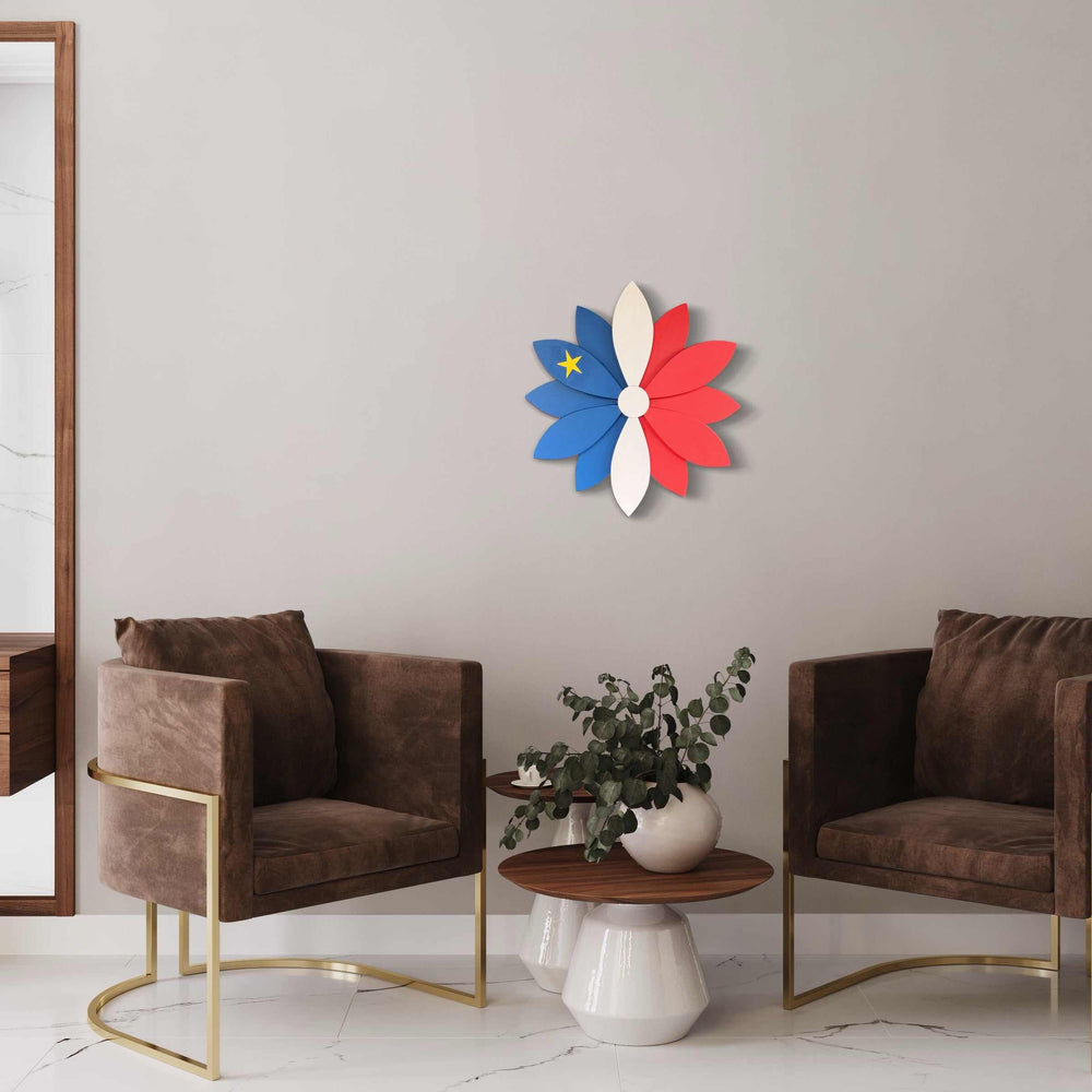 24" Acadian heritage flower design in solid pine with hand-painted colors and a laser-engraved star, wall-mounted in a modern living room setting.