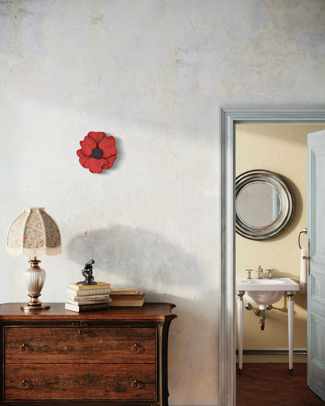 Windflower door decoration in red with a black center displayed on a wall, crafted from pine wood and coated with premium paint.