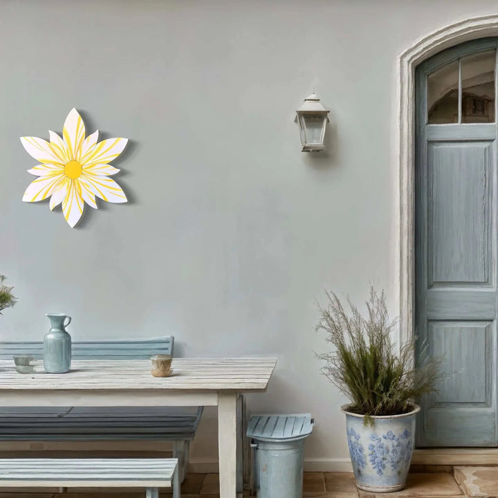 Handcrafted Curled Top Petal Flower wall decor in yellow and white, enhancing a charming outdoor space.