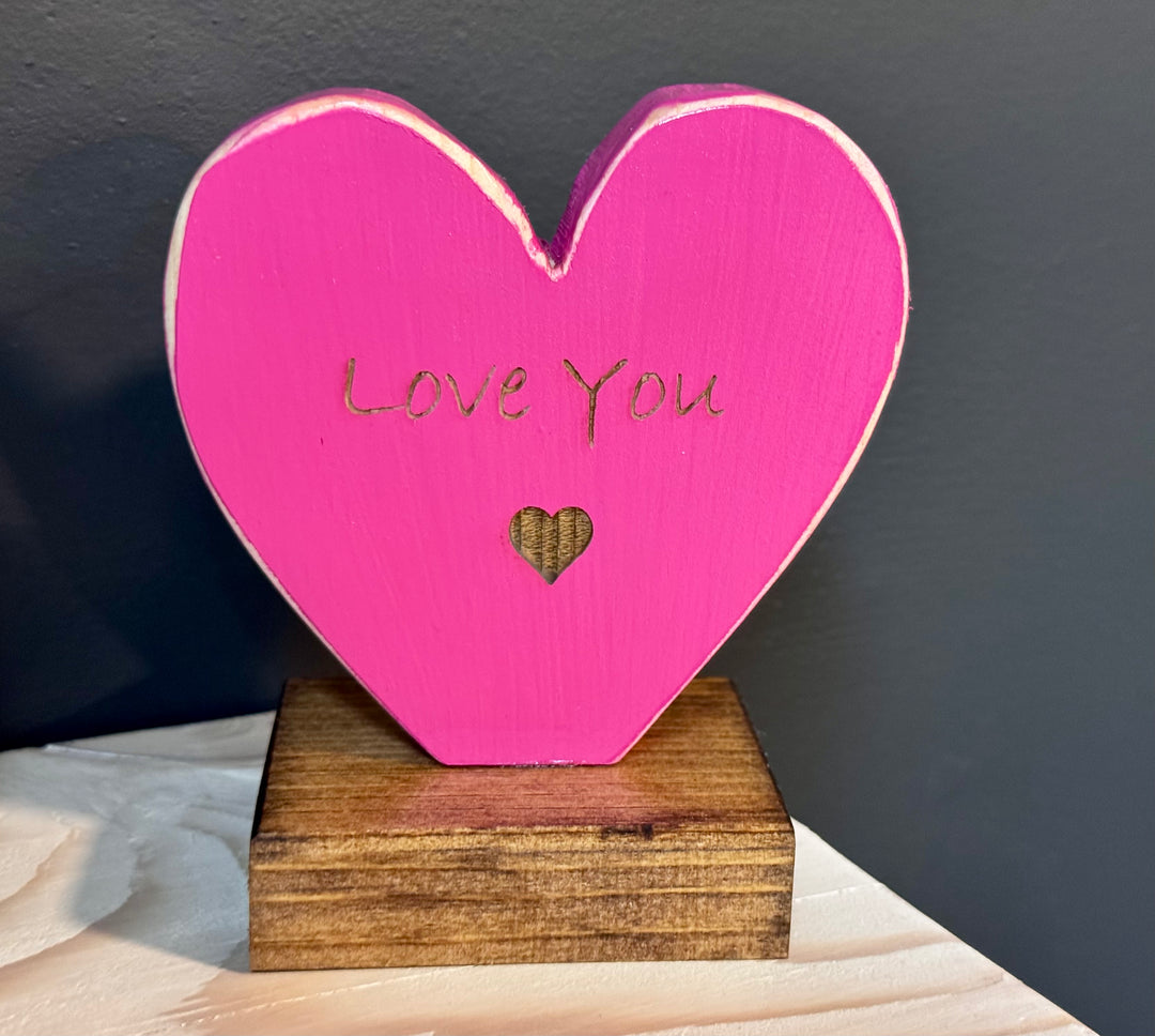 Pink heart-shaped wooden plaque with &