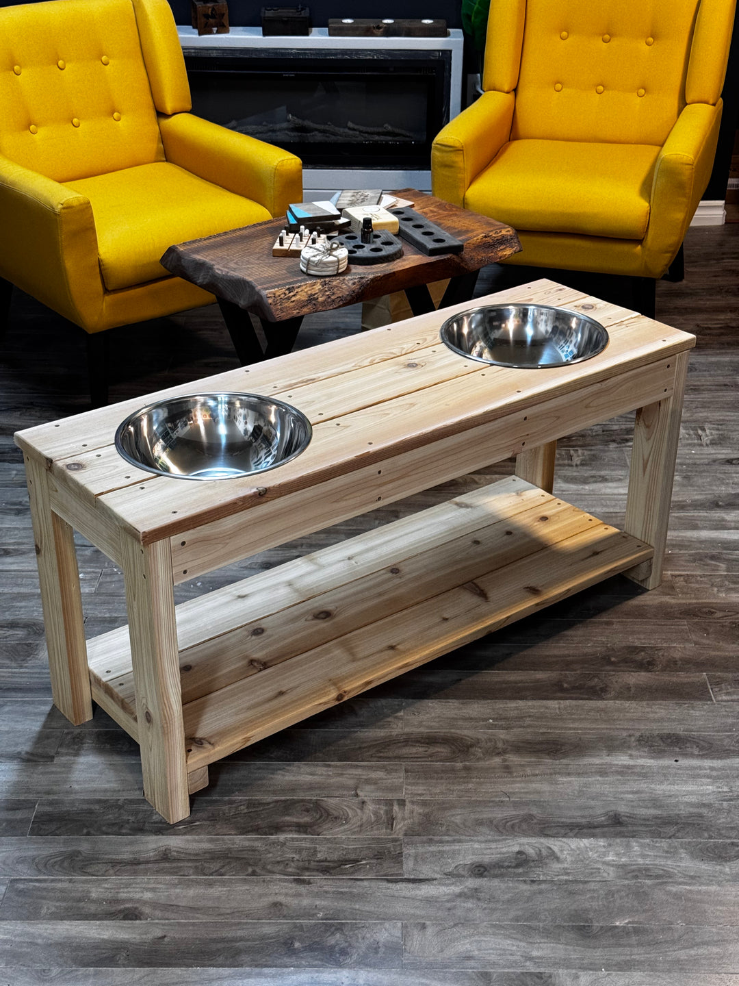 Wooden table with metal dog bowls in a living room setting