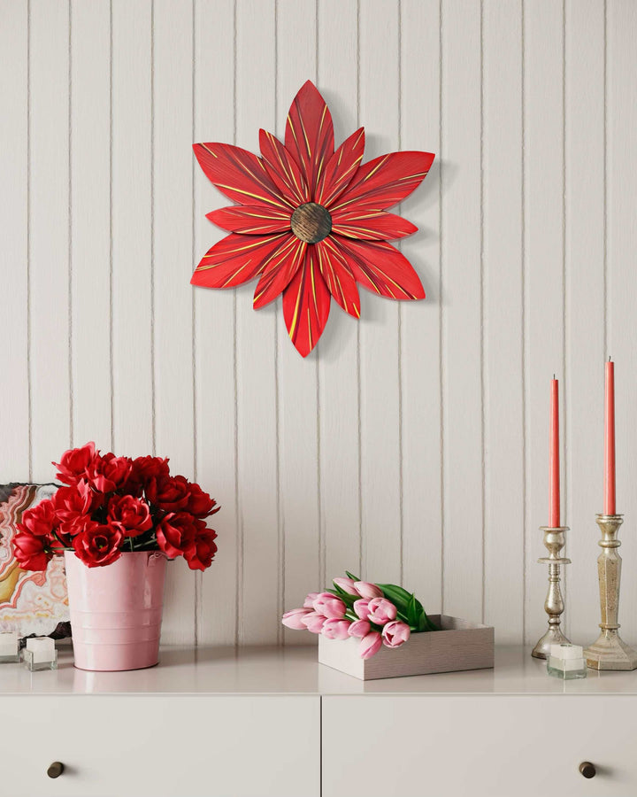 Wooden red and gold flower door decoration on wall, enhancing home decor.