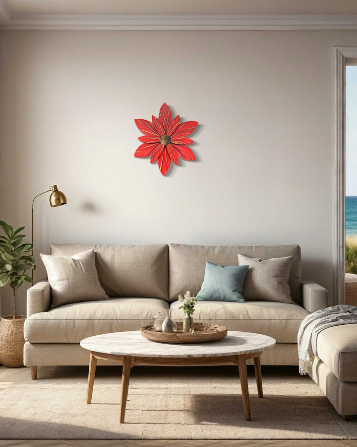 Wooden flower art door decoration featuring red and gold hand-painted petals on a beige wall above a sofa.