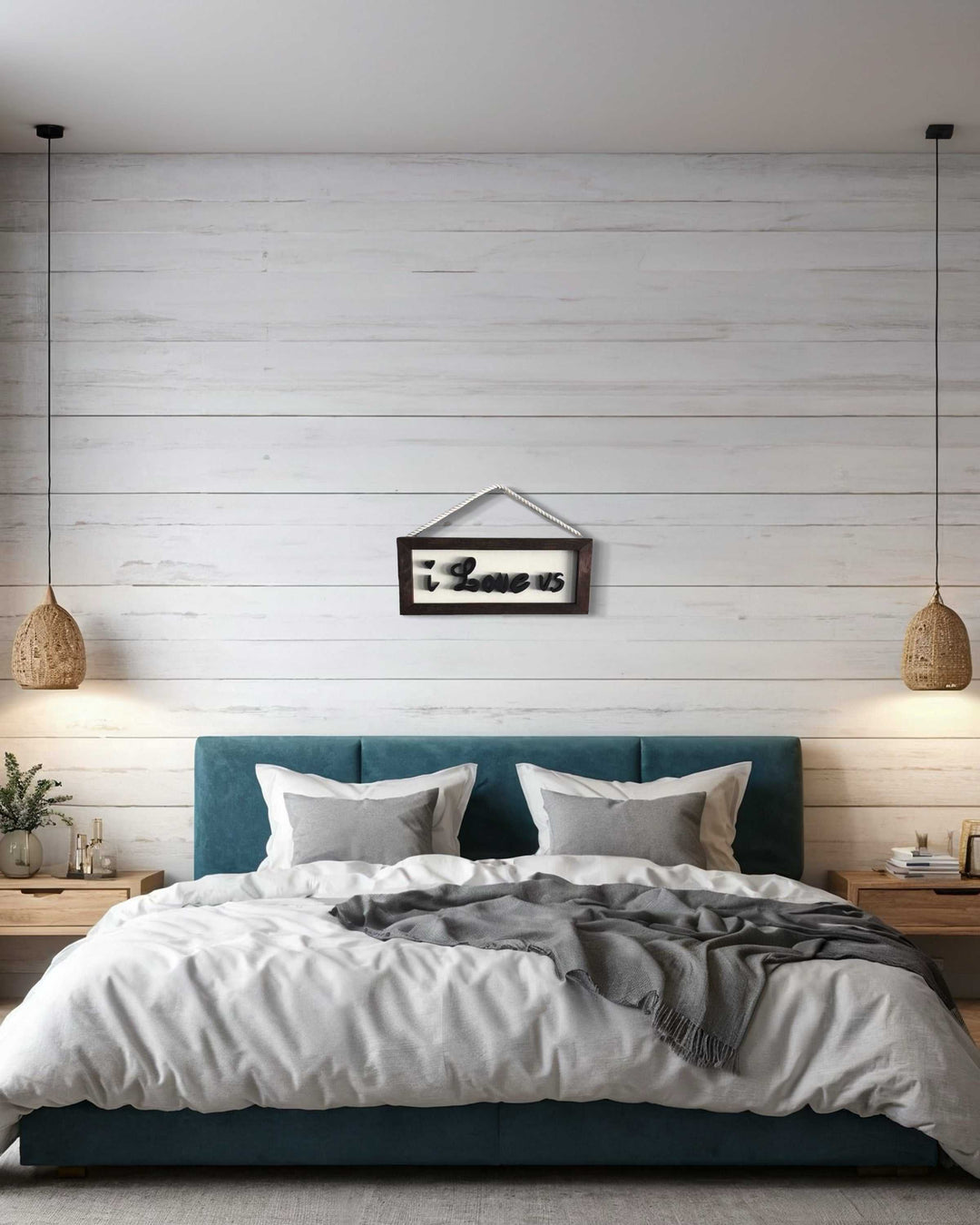 Artisan-crafted wooden sign "I Love Us" with frame hanging above bed in modern bedroom.