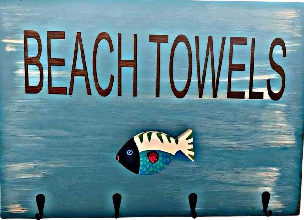 Hand-painted wooden beach towel holder with engraved fish design and four metal hooks.