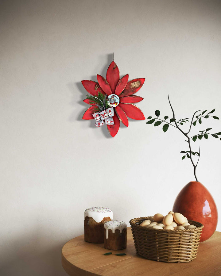 Hand-painted Christmas flower gnome décor on a wall above a wooden table with a vase, basket of eggs, and bread.