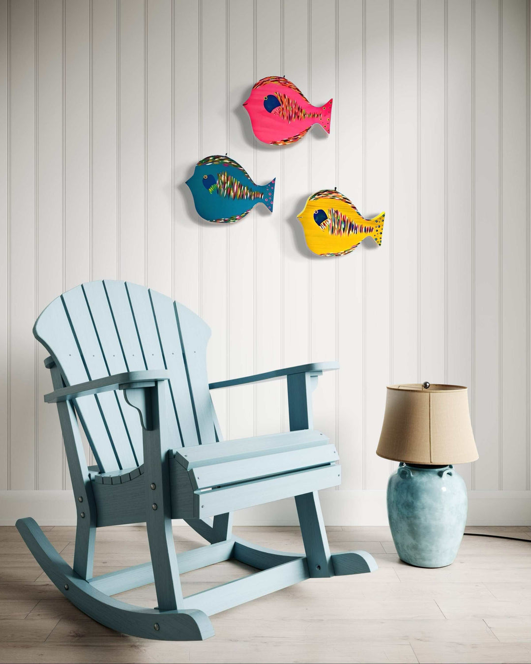 Hand painted folk art fish wall decor in vibrant colors, displayed on a white panel wall.