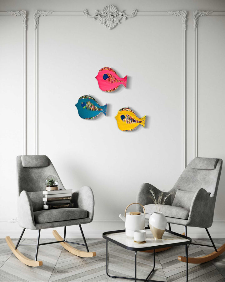 Hand painted folk art fish on wall in modern living room setting.