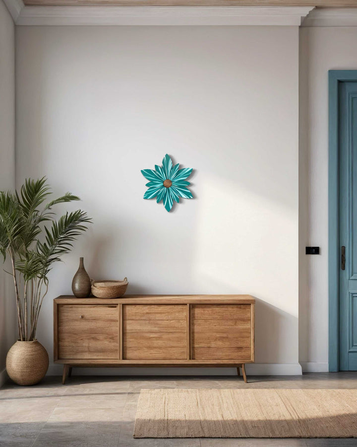 Handcrafted juniper green wooden flower door decoration on white wall above wooden console table.