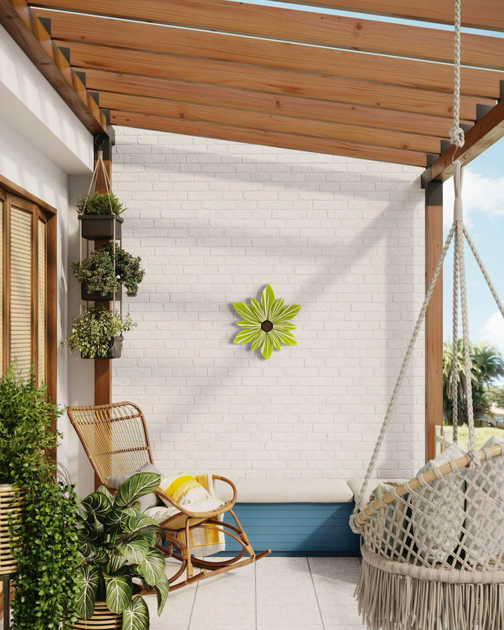 Handcrafted lime wood flower art on patio wall.