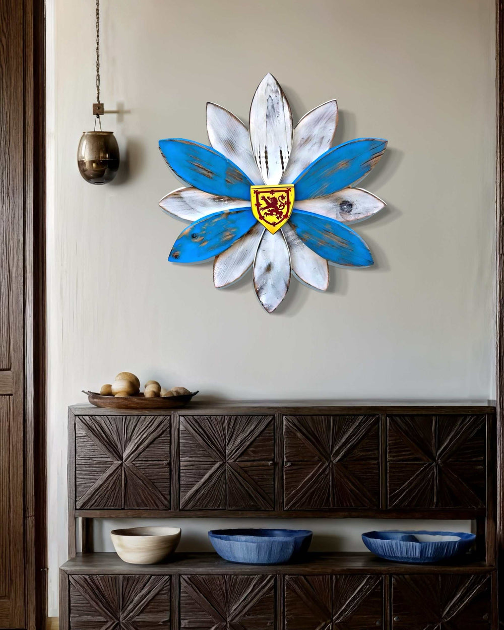 Handcrafted Nova Scotia wooden flower art piece on interior wall, featuring six petals for regional representation, vintage distressed look, and tartan material for weather resistance.