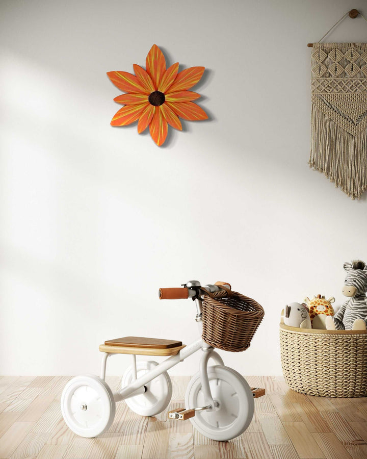 Handcrafted orange wood flower door decoration with yellow streaks.