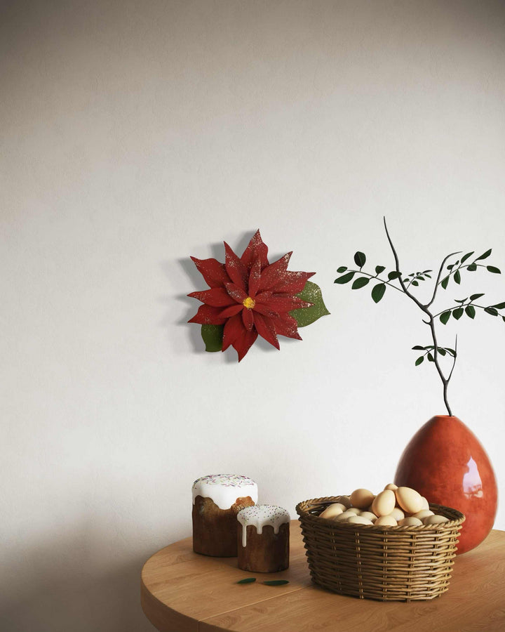 Wooden poinsettia flower decoration on wall with table setting.