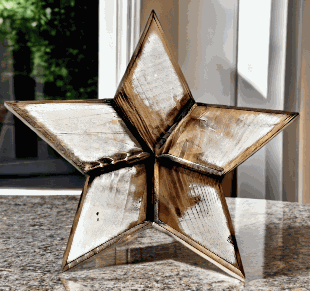 Handcrafted rustic wooden star Christmas tree topper on a table.