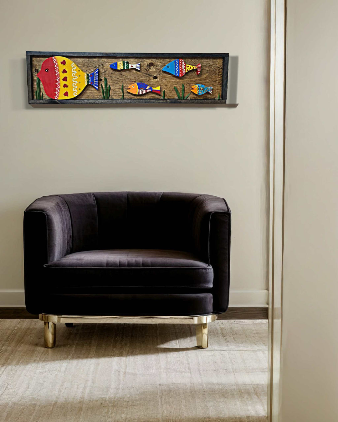 Handmade wooden fish wall art hung above a chair, featuring vibrant hand-painted colors and intricate details, measuring 37.5" x 10.75".