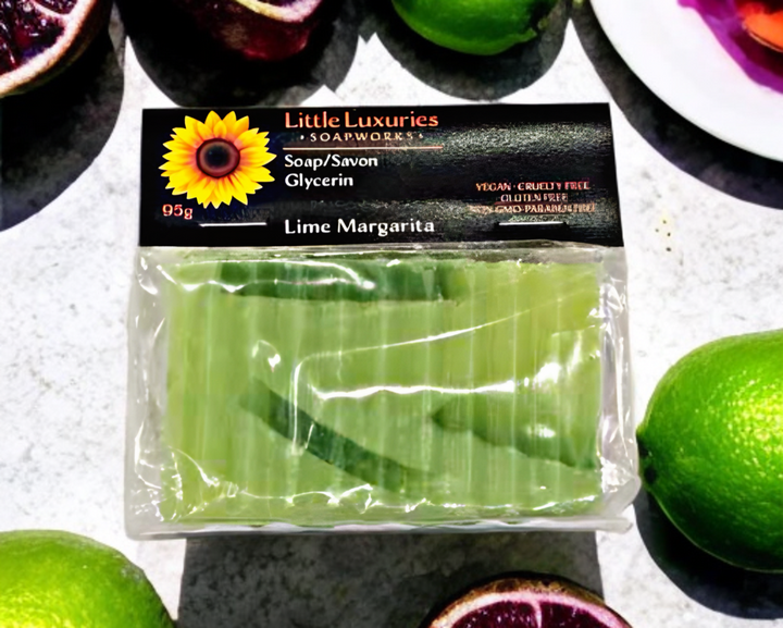 Lime Margarita glycerin soap in packaging, 95g artisanal bar for moisturizing skin care, surrounded by fresh limes.