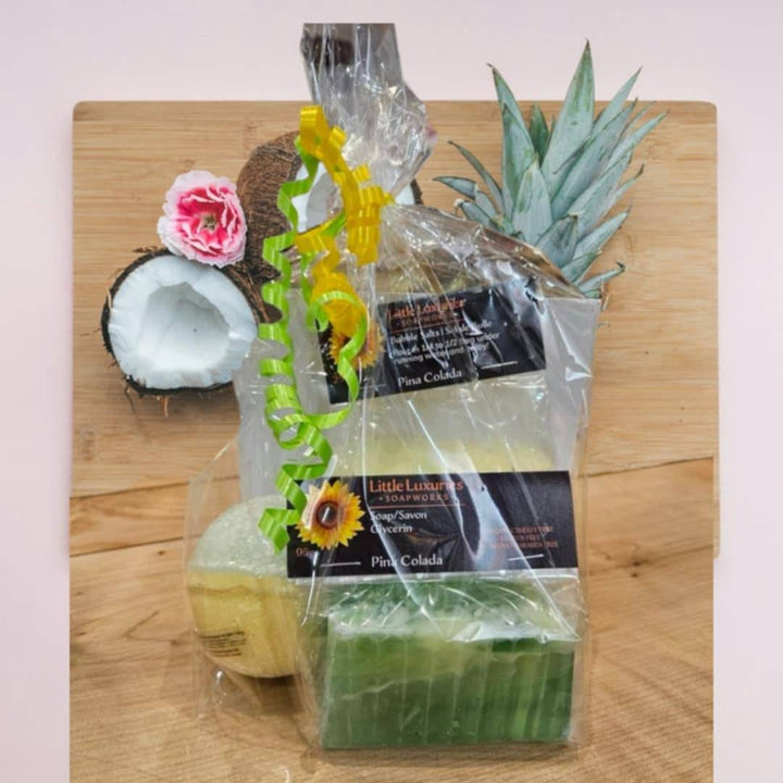 Gift pack featuring soap, bath bomb, and bubble salts with tropical decoration, perfect for self-care and gifting.