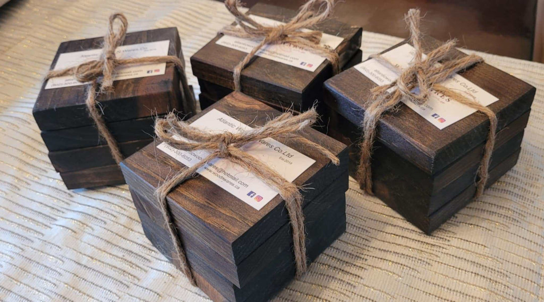 Handcrafted rustic wood coasters set of 4 tied with twine on a fabric surface.