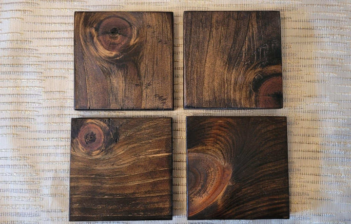 Set of 4 handcrafted rustic wood coasters with natural grain.