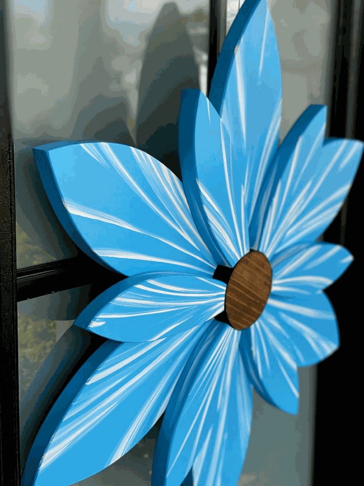 Handcrafted Bahama Sea Ocean Spray wood flower decor in blue with brown center, suitable for indoor or outdoor use.