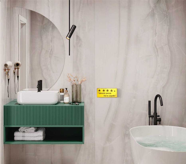 Rustic bathroom decor with "Would Poop Here Again" sign, adding humor and style.