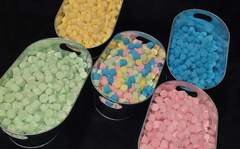 Colorful mini bath bombs in metal trays for foaming fun and relaxing baths kit
