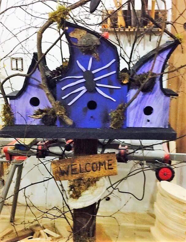 Triple compartment birdhouse with custom design, featuring purple paint and decorative spider motif, ideal for gardens.