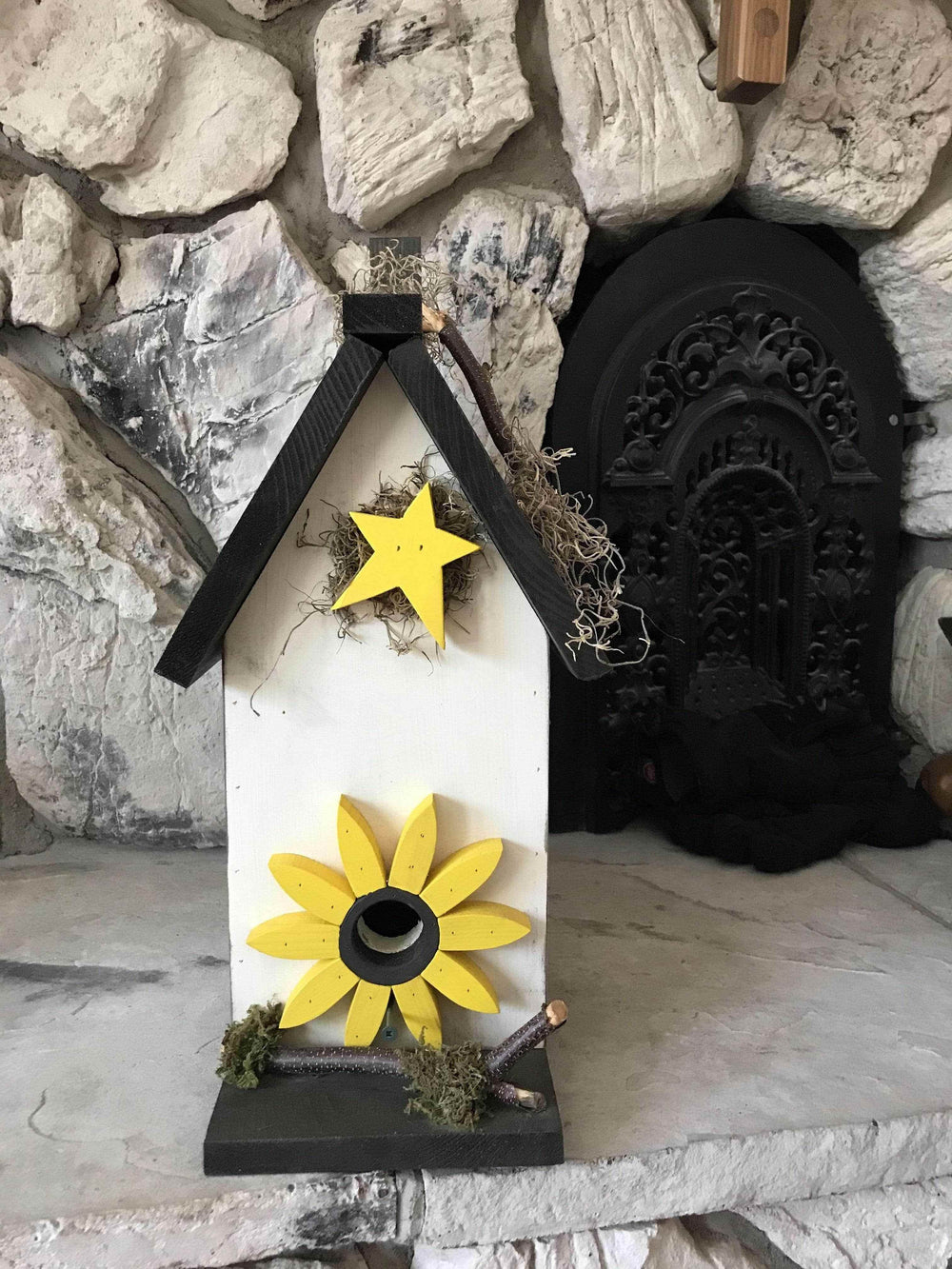 Handmade pine birdhouse with customizable colors and sayings, designed for outdoor use, featuring a decorative yellow flower and star.