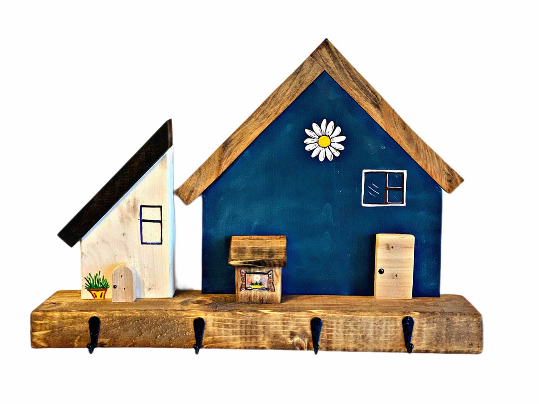 Handmade wooden key chain holder with painted village house design.