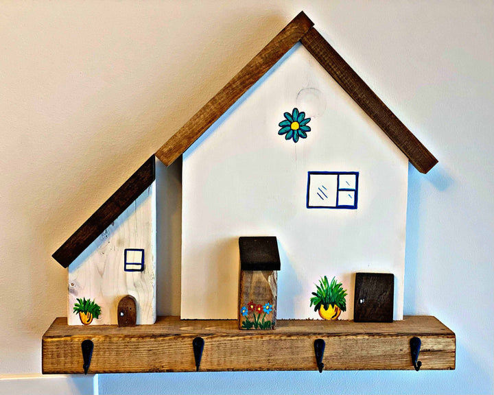 Handmade wooden village house key chain holder with hooks for wall hanging.