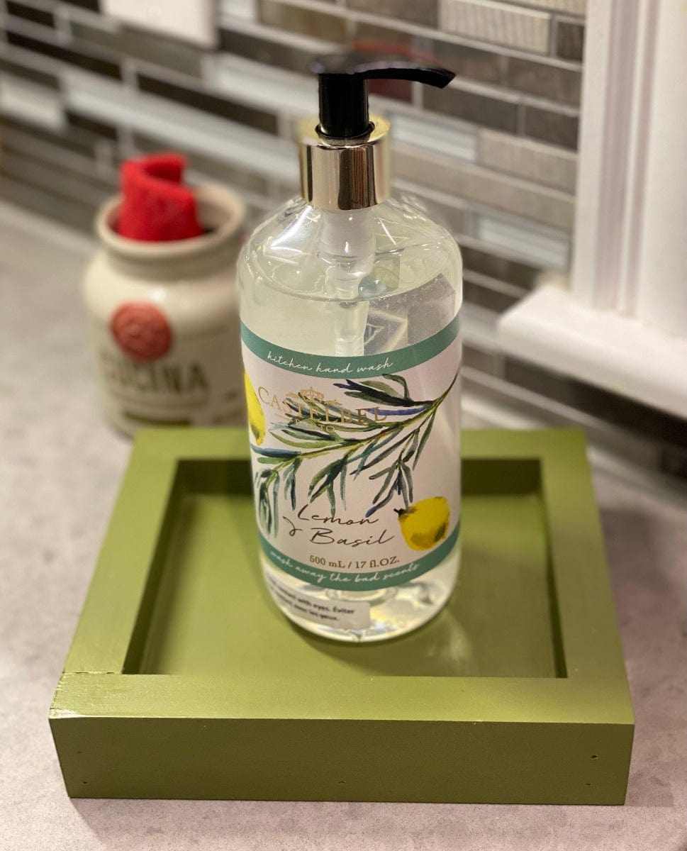 Handcrafted pine soap dish with olive green finish, featuring a decorative liquid soap bottle on a countertop.