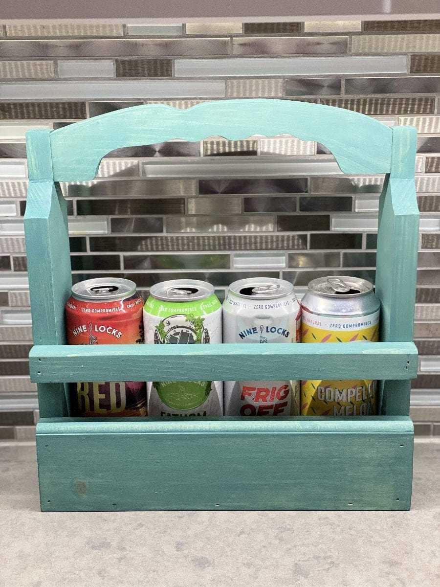 Rustic beer caddy holding four beer cans, handcrafted from pine wood.