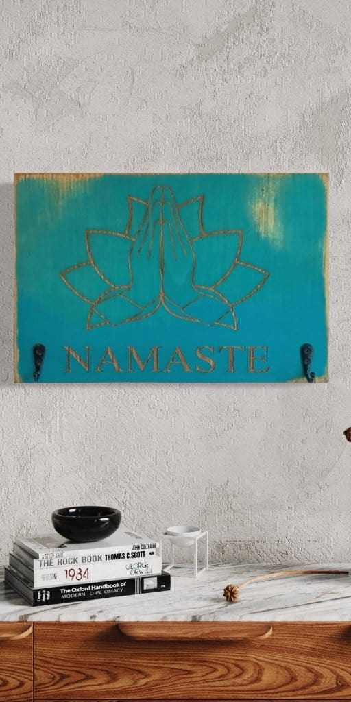 Namaste keychain holder with laser engraved design in surf blue, featuring two hooks. Perfect for yoga enthusiasts.