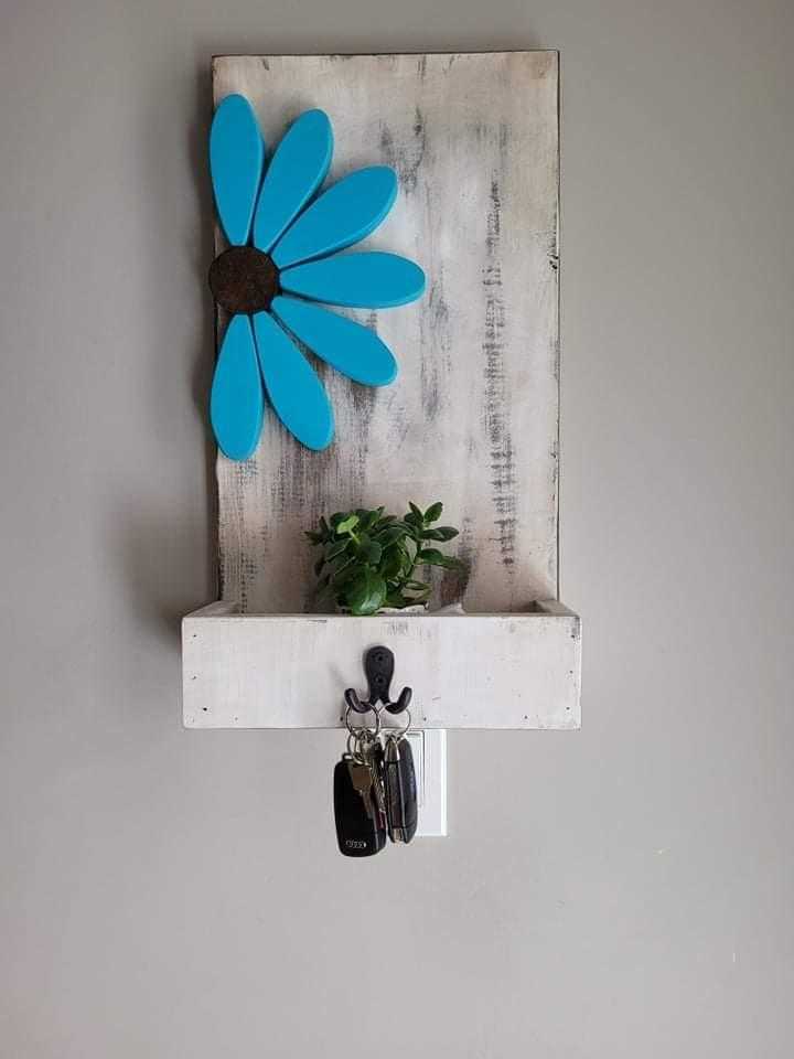 Entryway key chain holder with blue flower design and double hook on pine wood.