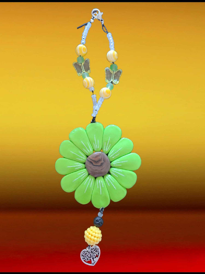 Sofia Daisy Car/Window Charm with green petals, polymer clay design, and beads for IWK Foundation support.