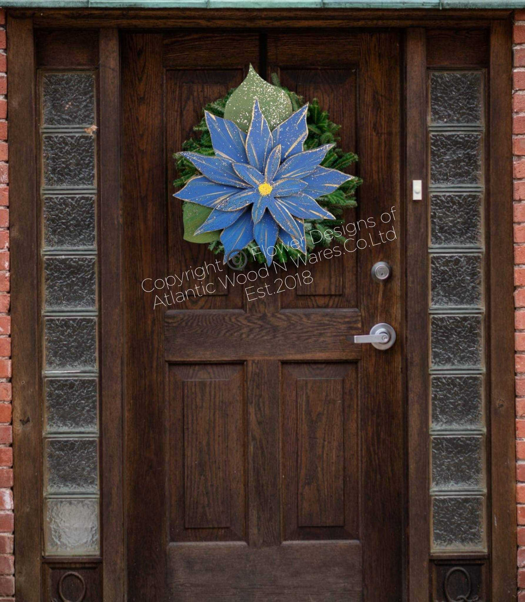 Wooden poinsettia flower decoration on a wooden door with glass panels, holiday decor.