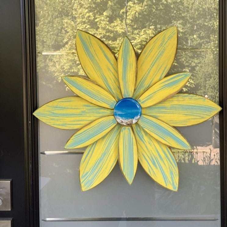 Yellow wooden flower with unique resin center for door decoration, handcrafted by Woodnwares in Nova Scotia, measuring 22x22 inches.