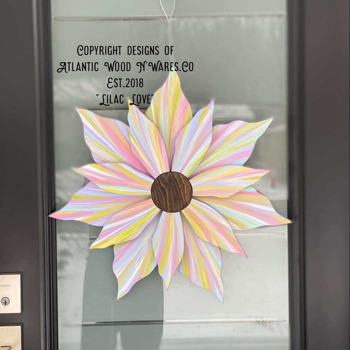 Handcrafted Love Flower door decoration in pastel colors with a wooden center, suitable for all seasons.