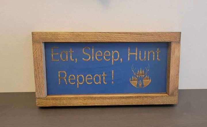 Laser engraved wood sign with "Eat, Sleep, Hunt, Repeat!" design, perfect for outdoor enthusiasts.