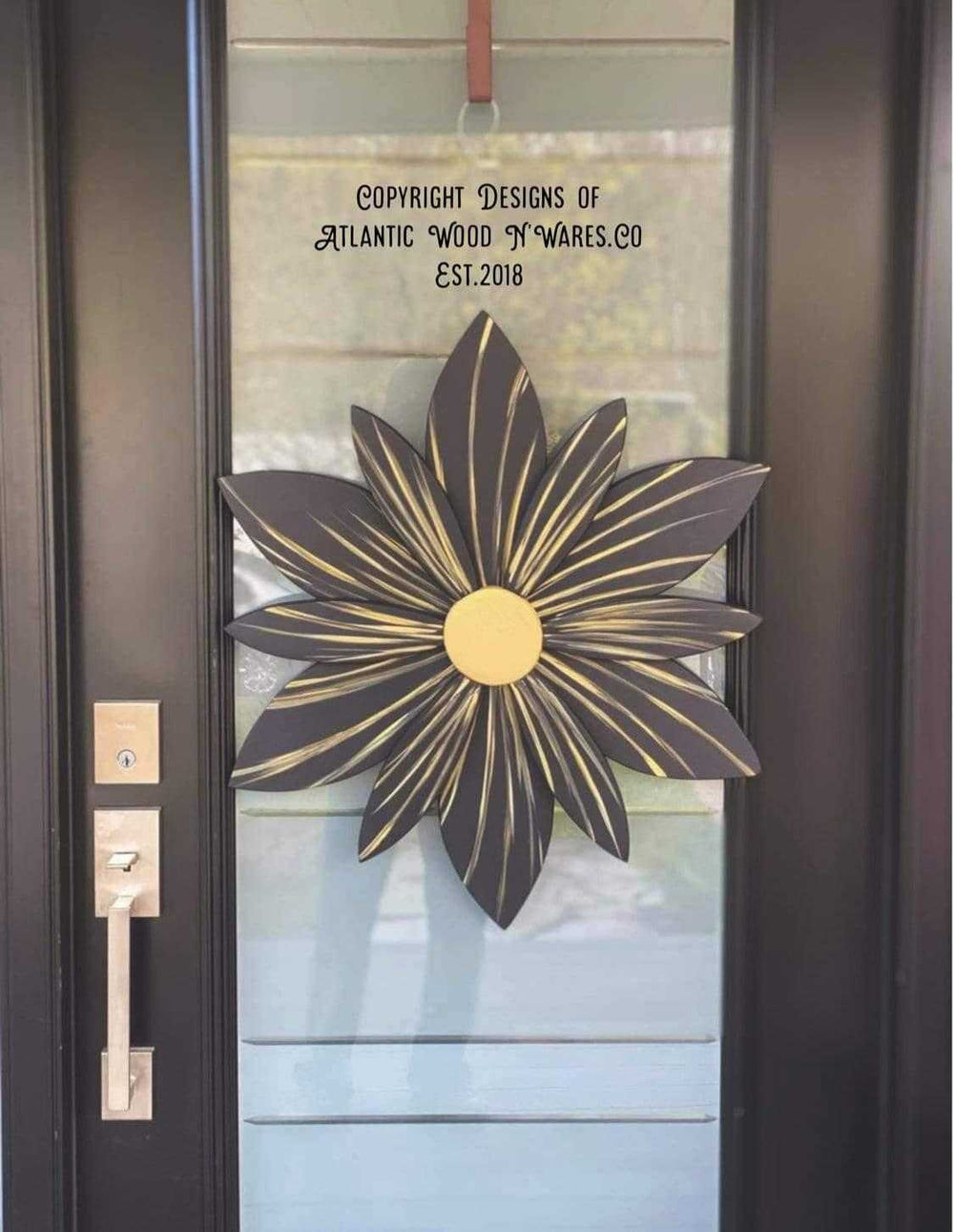 Golden Onyx wooden flower door decoration with black and gold accents, handcrafted for elegance.