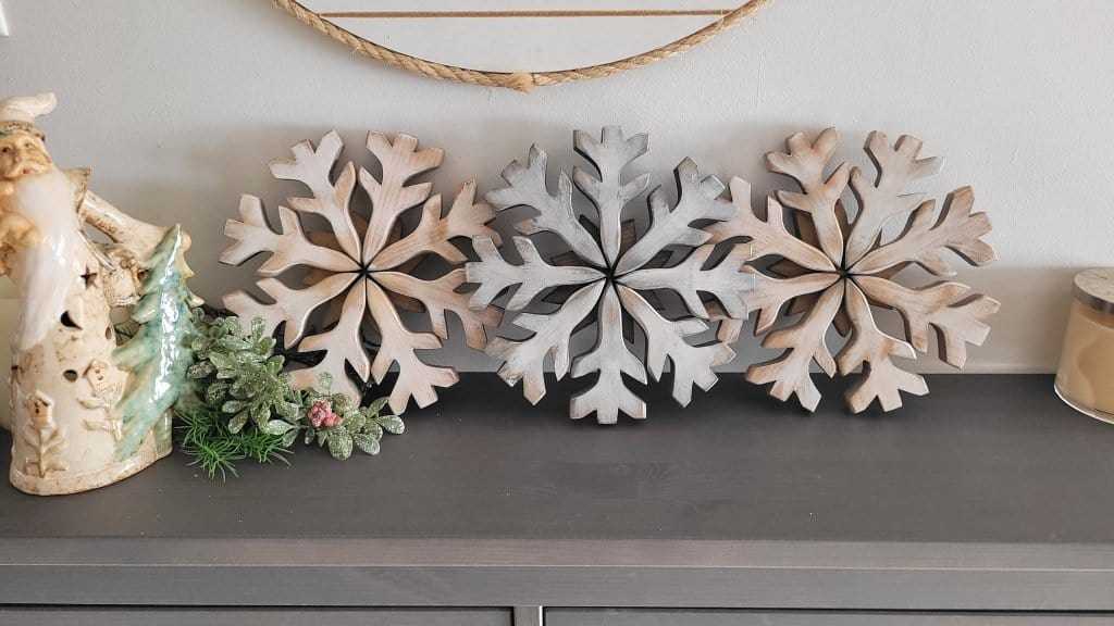 Handmade wooden snowflake decorations on display.