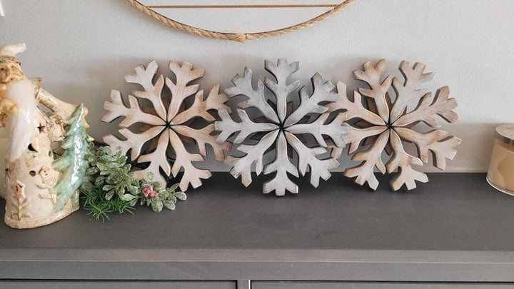 Handmade wooden snowflake decorations on display.
