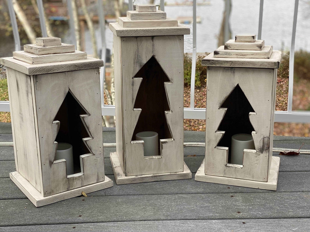 Handcrafted natural wooden lanterns with tree cut-out design, available in various sizes and perfect for indoor or outdoor use.